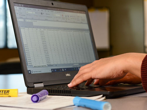 Hands typing on laptop computer.