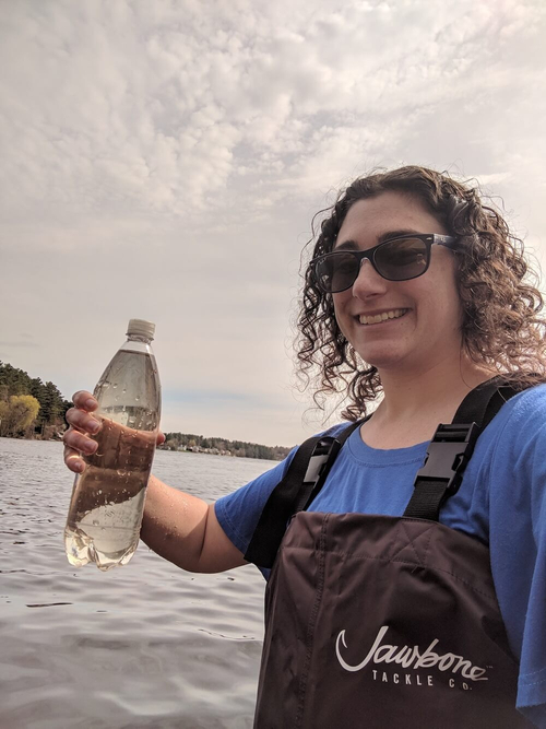 Rachel Buckley, a 7th grade science teacher, holding a bottle full of lake water.